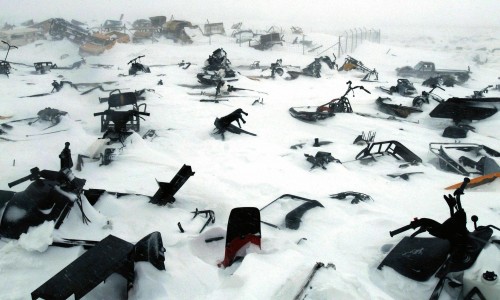 A skidoo dump/graveyard in the remote arctic village of Ivujivik, Nunavik, Quebec, Canada, April 2006.
Contact with Western societies has meant that the Inuit of arctic Canada have largely given up the use of dog sleds as their main form of transport in favour of the less environmentally friendly skidoo.
As the sea ice thins due to global warming accidents are becoming increasingly common as, unlike the team dogs who could smell salt water, the skidoo has no innate ability to know if the ice is safe to traverse.
It also serves as a reminder of the vanishing Inuit culture which, some predict, will be gone within two generations.